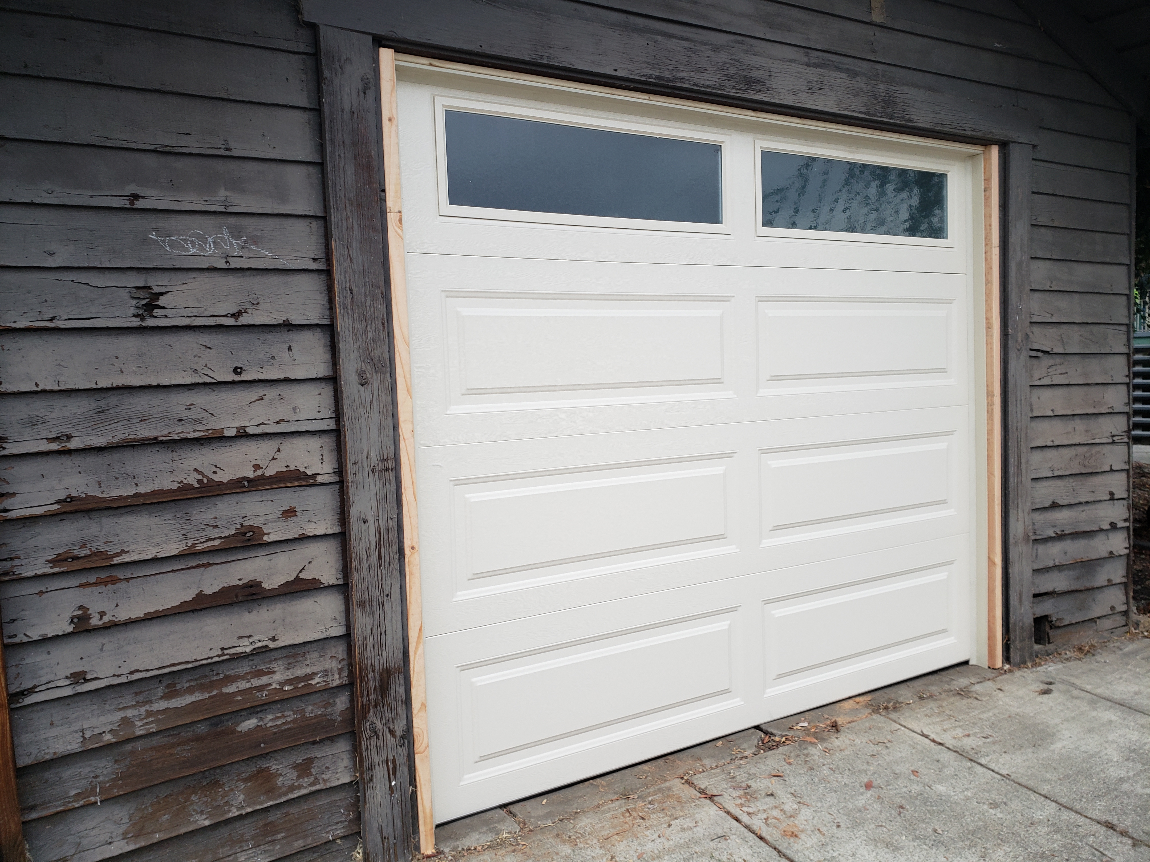 After clean white garage door replacement